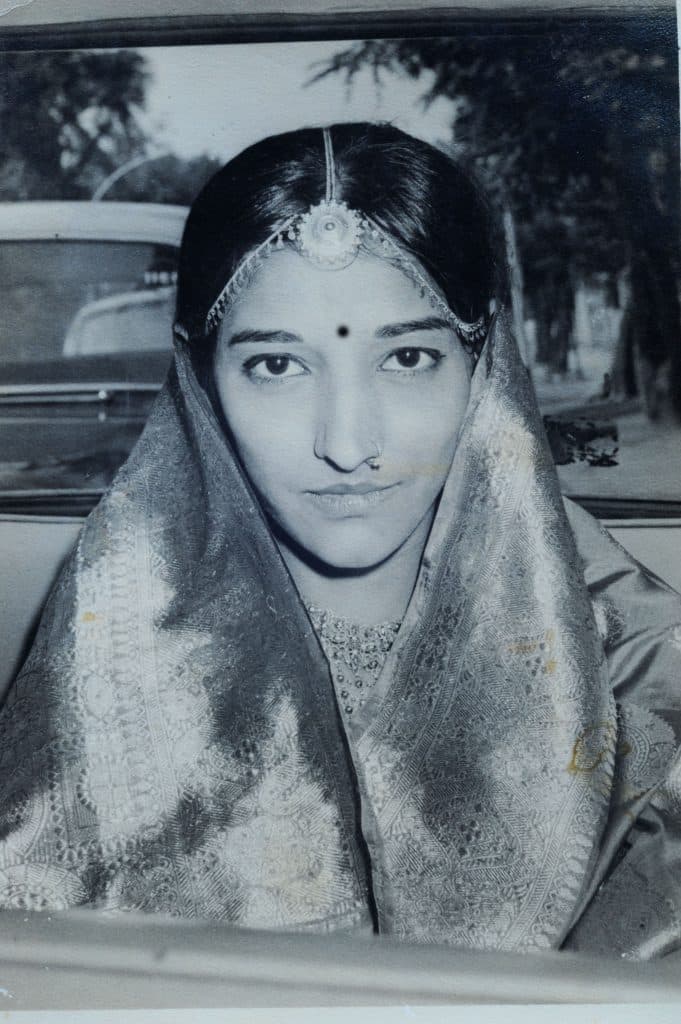 An antique Vintage Black and white Portrait of a smiling 20 year old young girl.