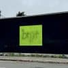 "Brat" album cover on a billboard.