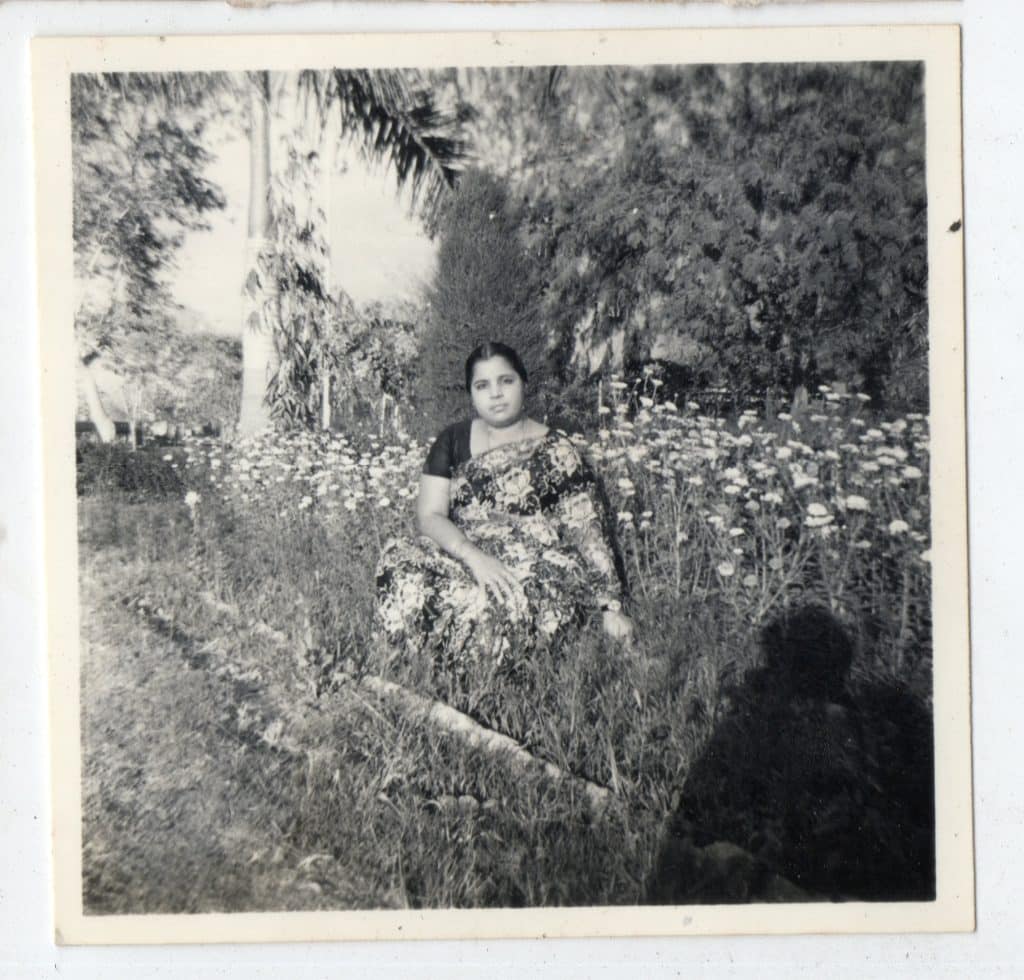 Black and white photo of a woman in a Sari dress during the British Colonial period.