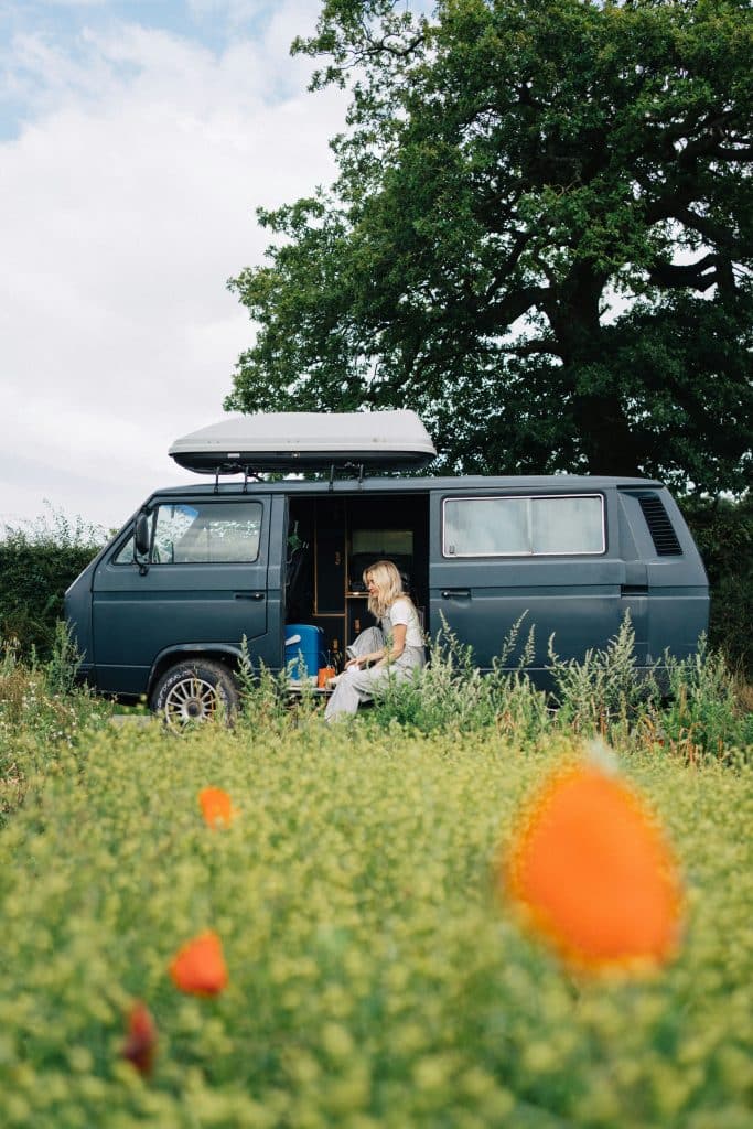 A young woman pictured sitting inside a renovated van