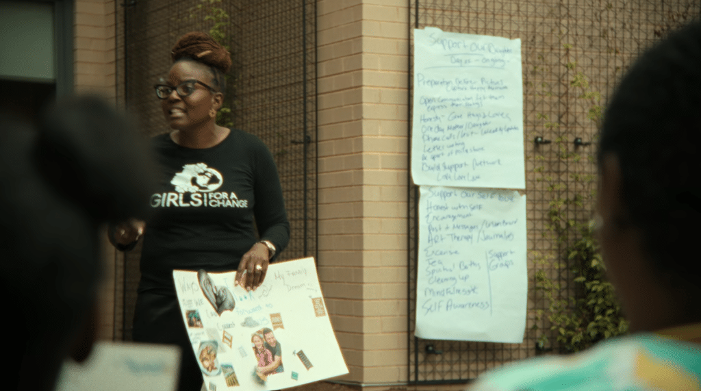 Angela Patton speaks to the daughters participating in the program, as well as their mothers.