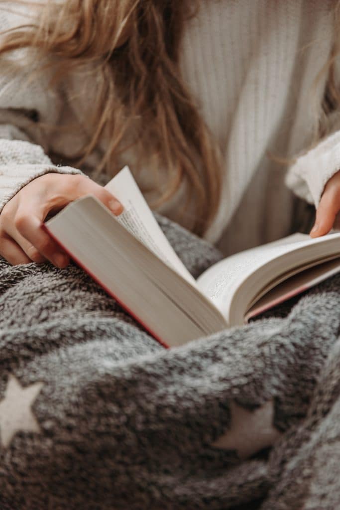 Photo of a girl reading.a book
