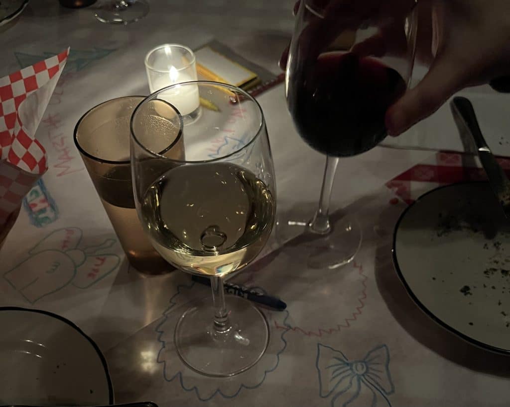 Wine glasses on a table with crayon drawings