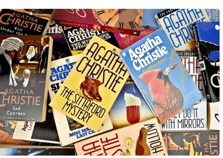 Various Agatha Christie novels piled together