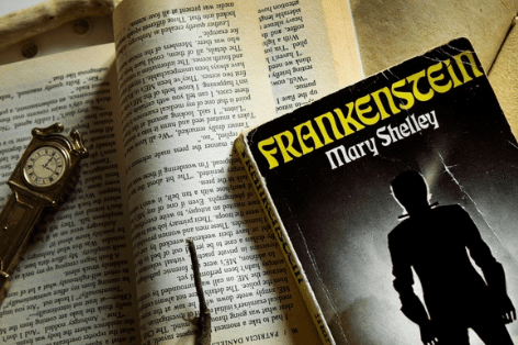 Frankenstein book leaning against another open book