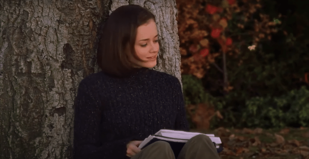 Rory Gilmore (played by Alexis Bledel) studying by a tree.