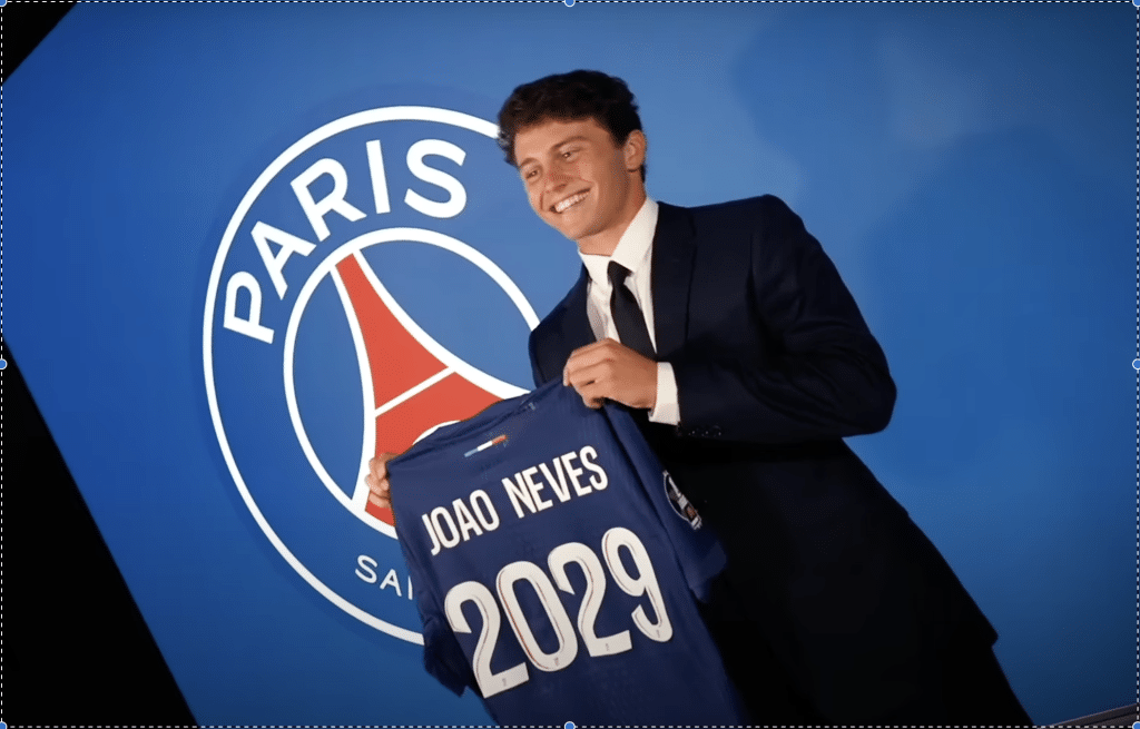 Joao Neves holding up a PSG shirt