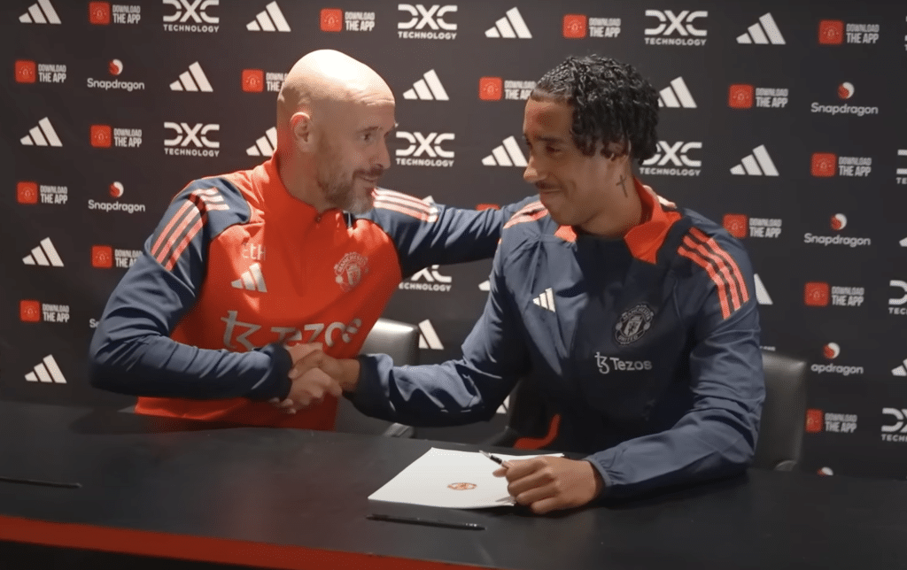 Leny Yoro shaking hands with Erik Ten Hag
