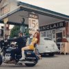 Chappell Roan on the back of a motorbike