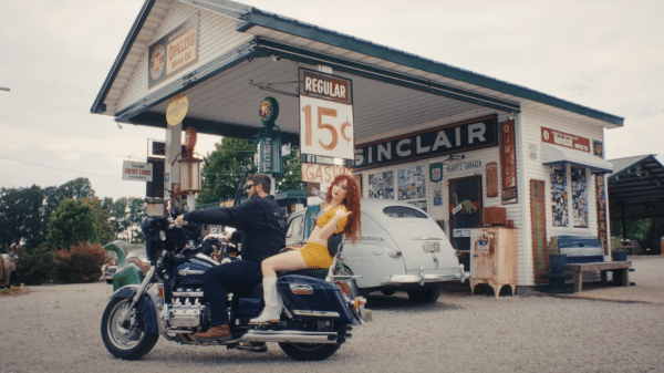 Chappell Roan on the back of a motorbike