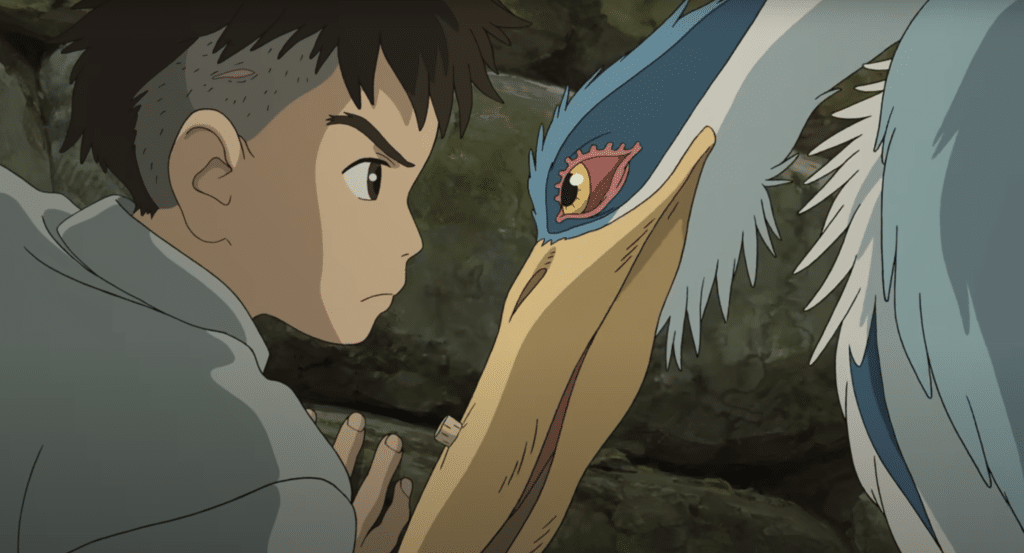 A boy has a staring contest with a heron.