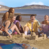 The Heartstopper group together on the beach as Charlie watches.