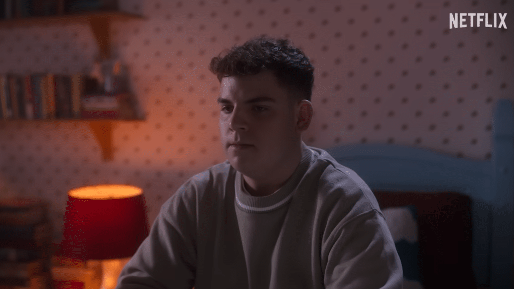 Heartstopper's Isaac sits in his room