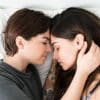 lesbian couple cuddling in bed