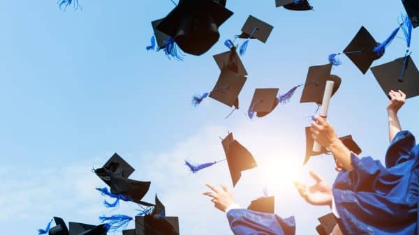 graduation caps in air