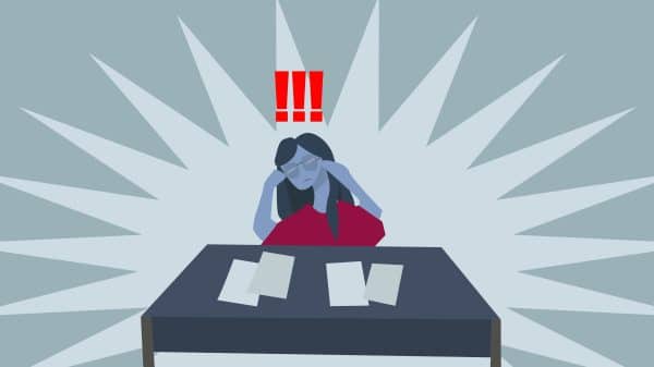 person sitting at desk stressed out