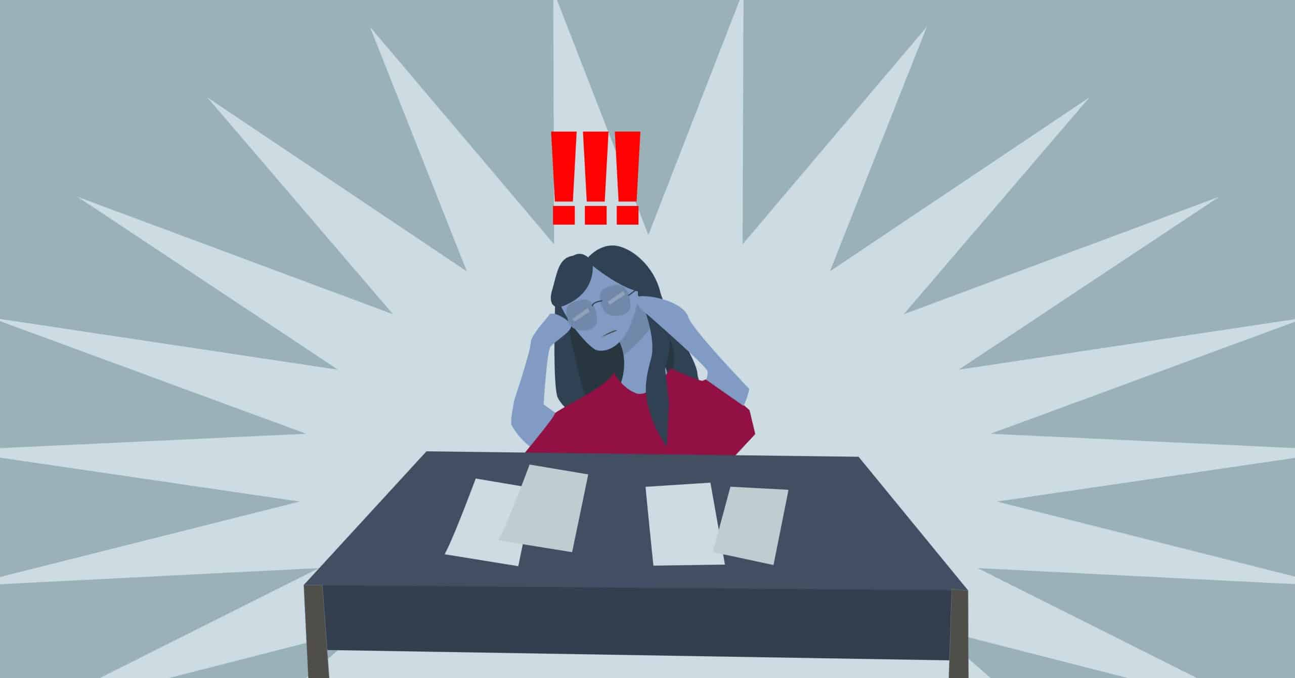 person sitting at desk stressed out