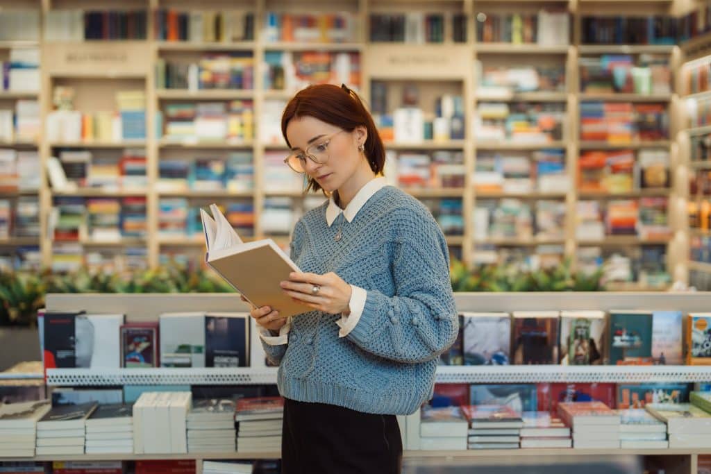 photo of a woman holding a book reading