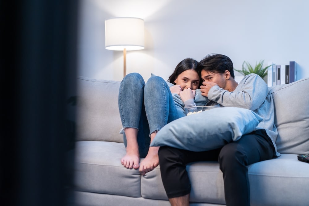 A young couple sat on a sofa