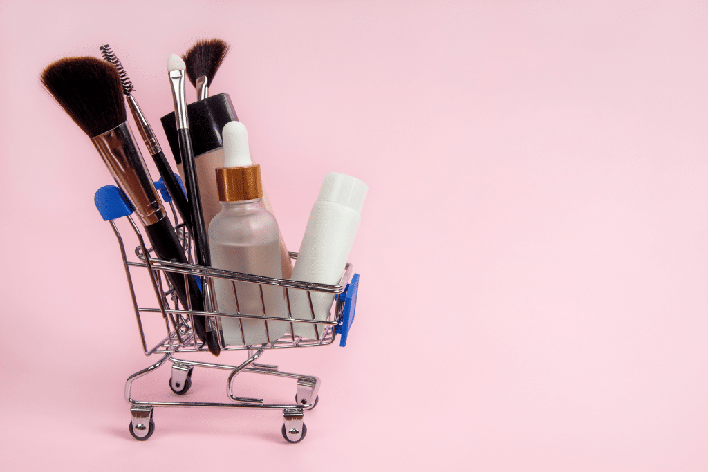 Natural base products such as primer and BB cream sitting in a miniature shopping cart.
