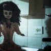 An ugly doll sits eerily of the counter.