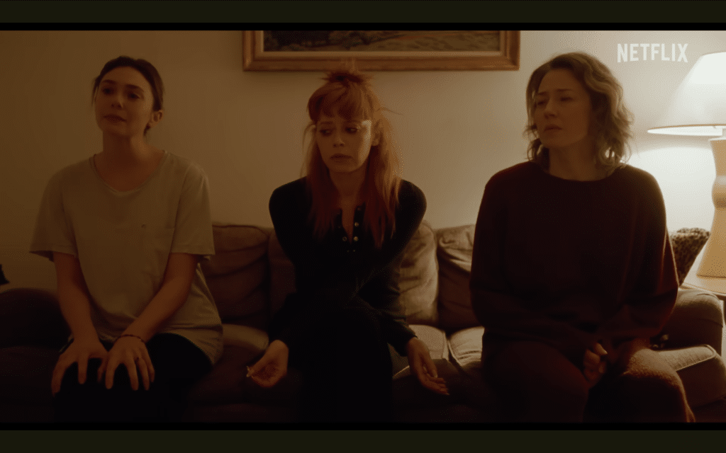 A screenshot of the trailer for "His Three Daughters" showing the three main leads sat together on a couch.