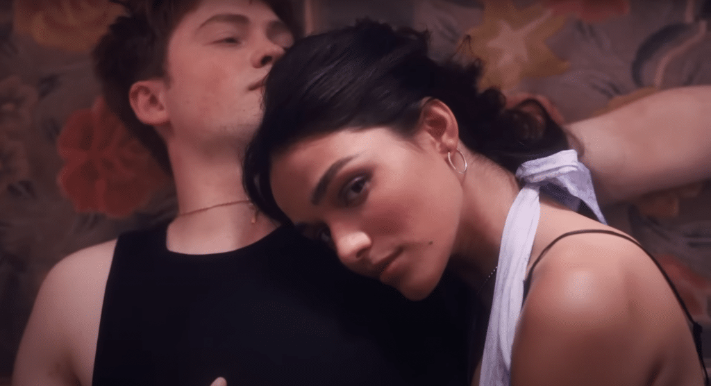 Kit Connor and Rachel Zegler laying down next to each other to promote their broadway show.
