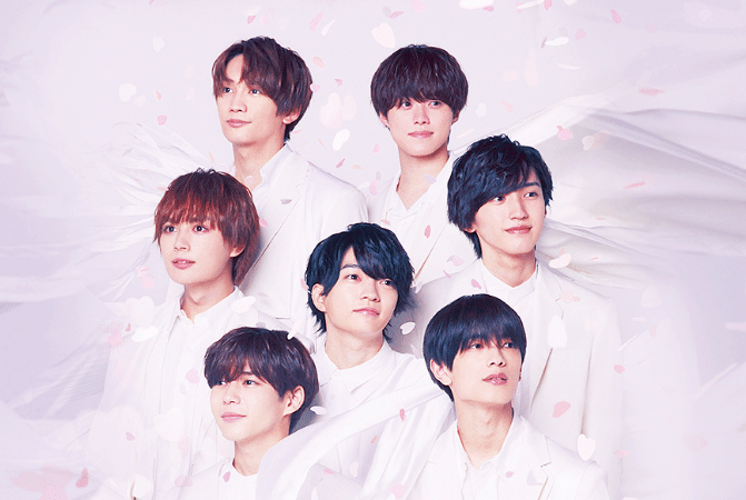Members of Naniwa Danshi dressed in white with flower petals falling around them
