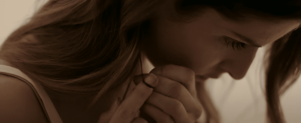 Anna Kendrick pulling her hair in a shot from Alice, Darling.