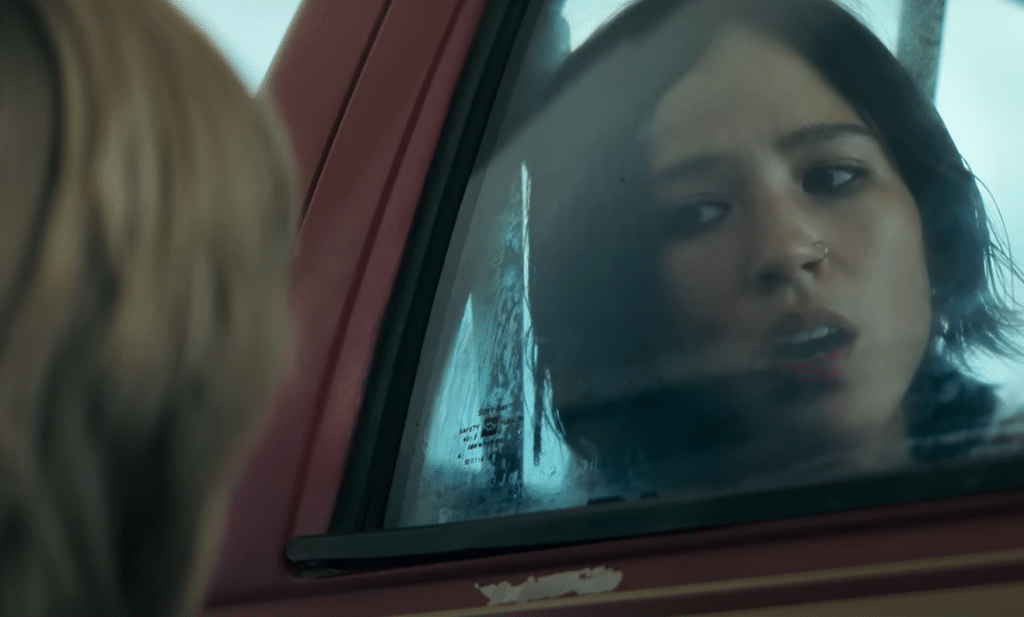 Iris, trapped in a car, tries to get help from a kid. Credit: Netflix