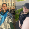 A split image, on the left a young woman smiling holding the medal around her nexk up wearing a thermal blanket, on the right a woman wearing black running gear taking a selfie smiling at the camera.