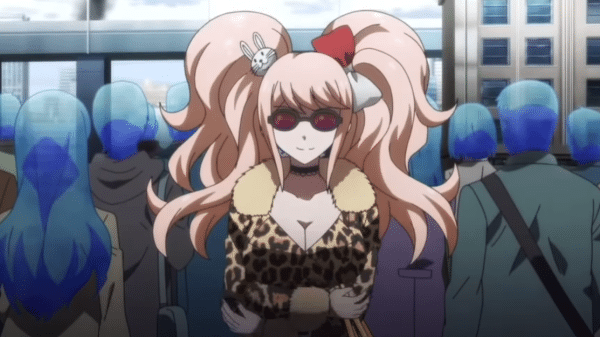 Junko Enoshima standing in sunglasses and a cheetah print dress