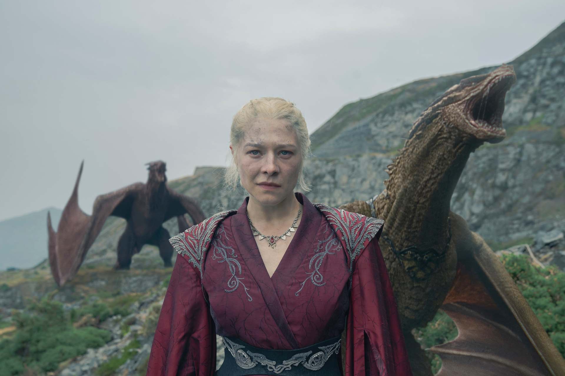 Still from House of the Dragon. Emma D'Arcy as Rhaenyra Targaryen standing in front of two large dragons