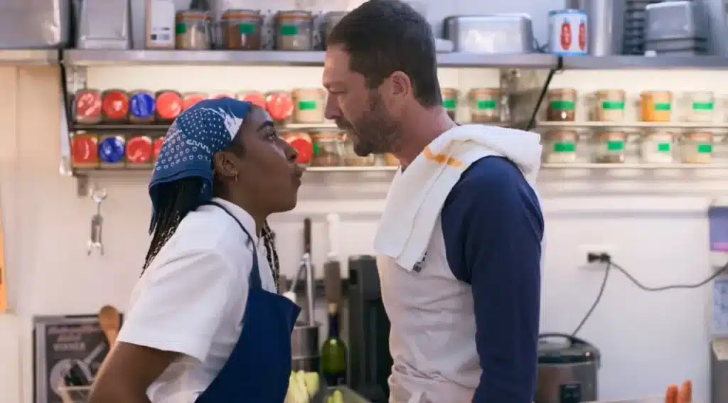 Sydney and Richie arguing in the kitchen with neatly cut tape on the food in the background