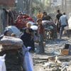 Palestinians inspecting the rubble of their homes