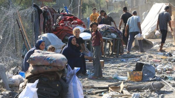 Palestinians inspecting the rubble of their homes