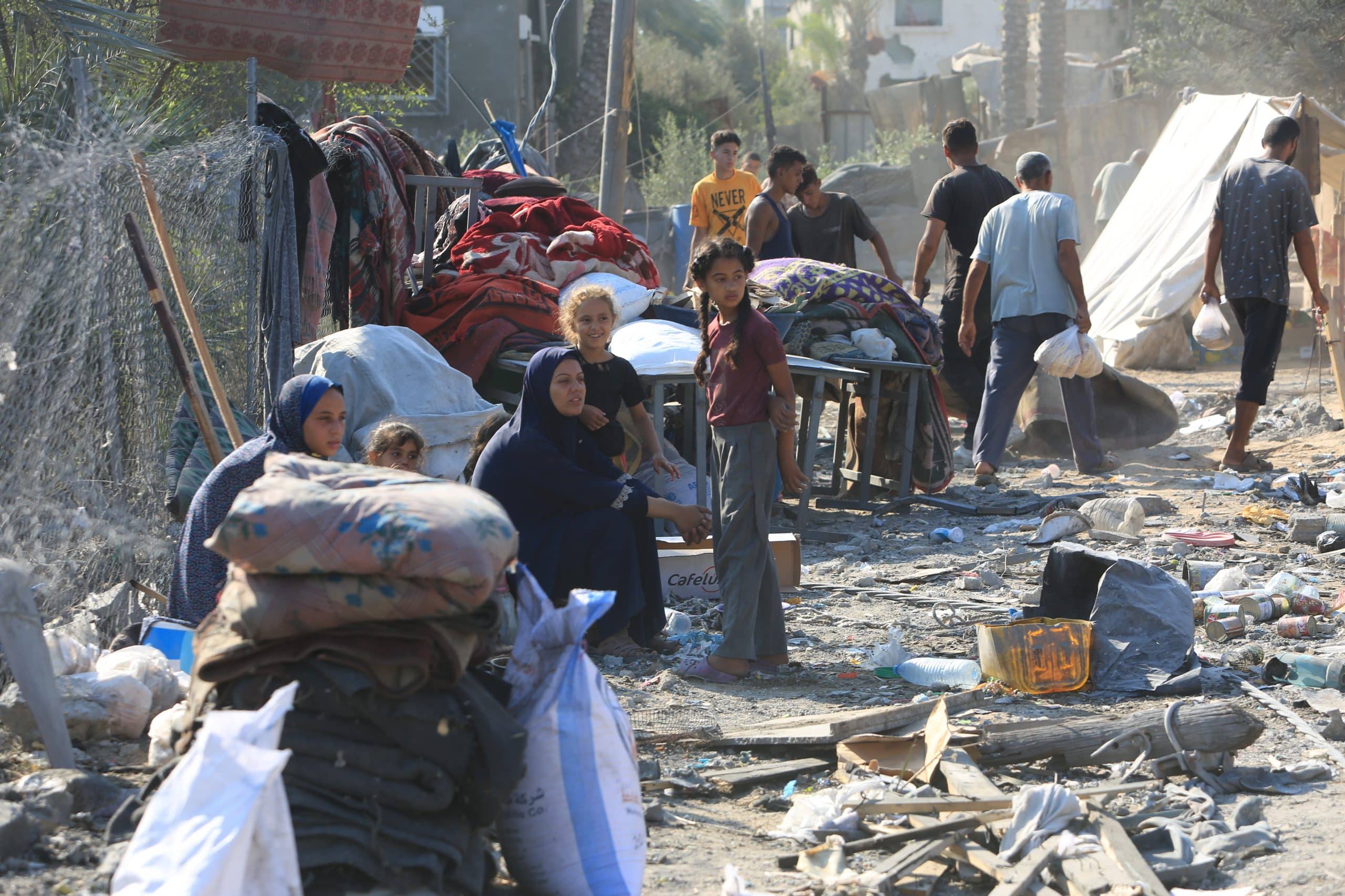 Palestinians inspecting the rubble of their homes