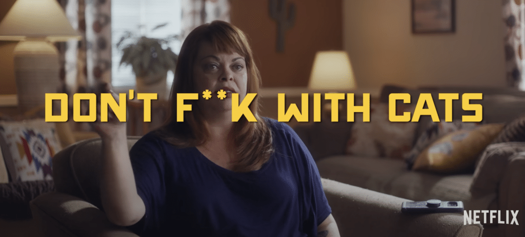 A seated woman making a 1 with her hands behind the text "Don't F**K With Cats" in a true crime documentary