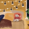 Illustration of a cozy room featuring a woman sitting cross-legged on a couch while looking at her phone. The room is warmly lit with string lights and hanging Polaroid photos on the wall. A small stuffed bear wearing a Santa hat and sweater sits on a cushion beside her. A large potted plant is placed near a window showing a nighttime scene with falling snow.