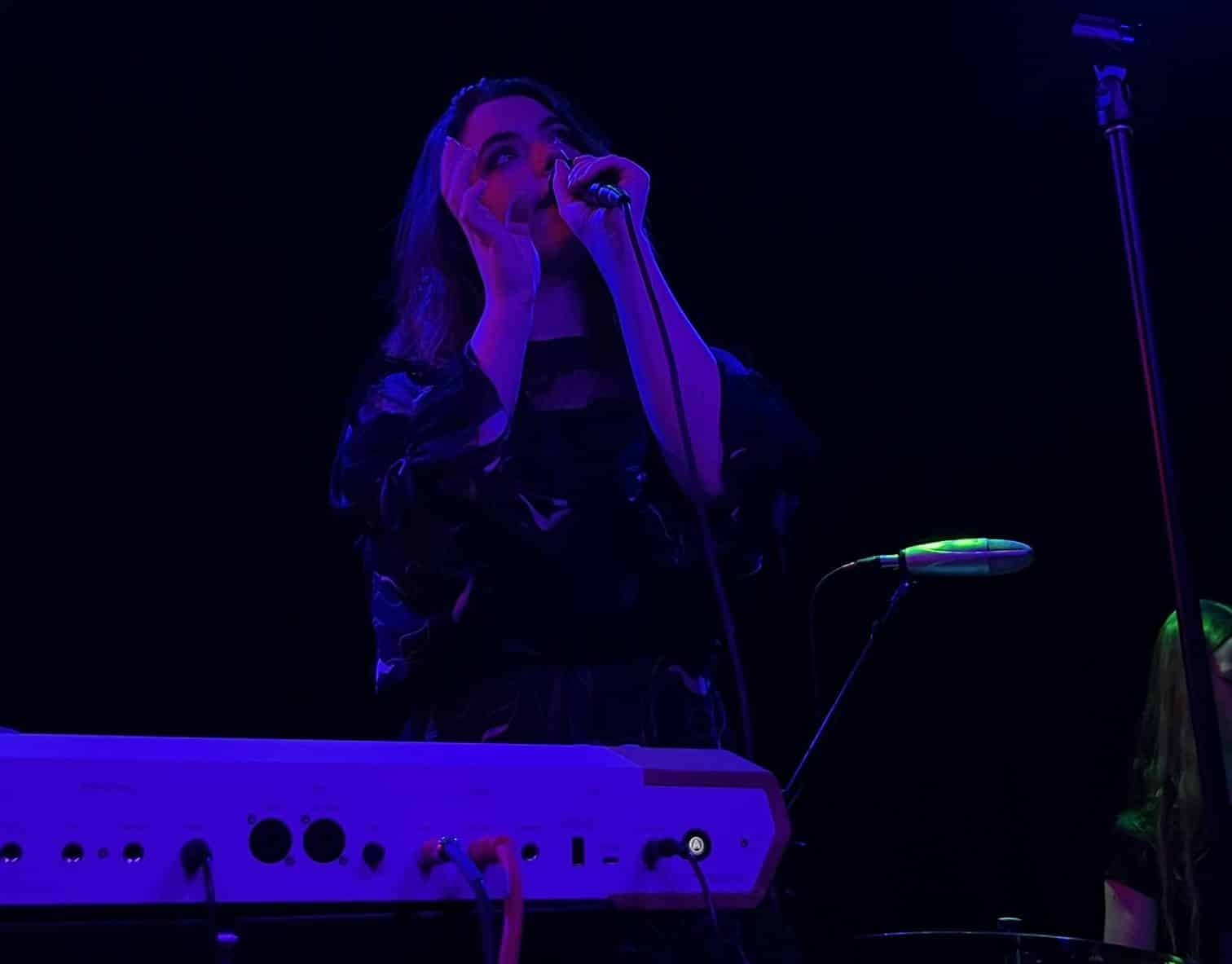 Genevieve Stokes singing at a concert.