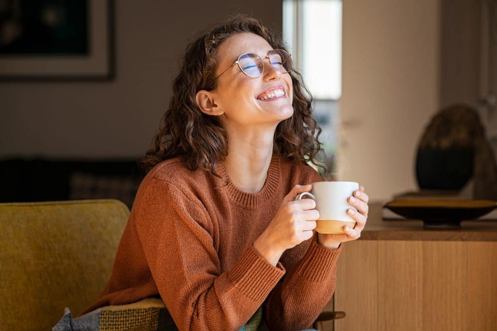 A woman sat enjoying a cup of coffee