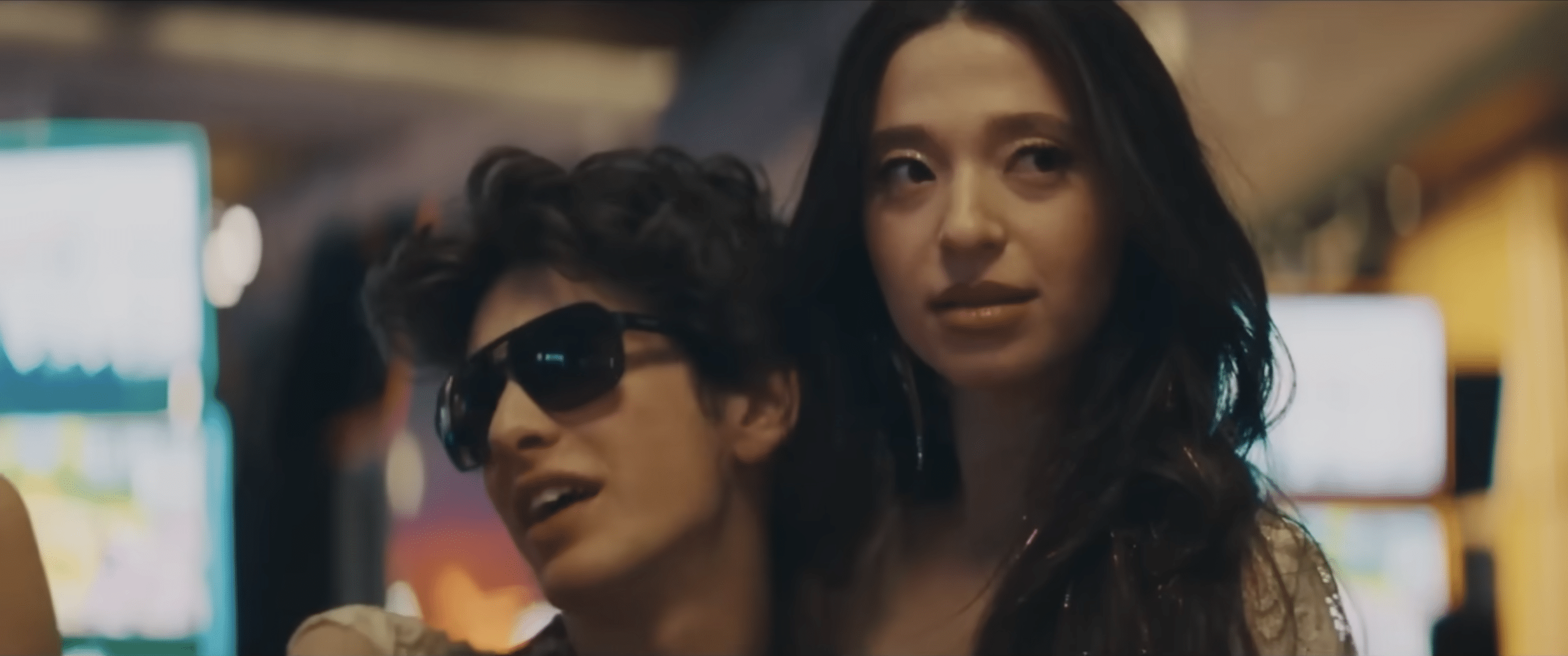 Ani, played by Mikey Madison, being held by Vanya Zakharov, played by Mark Eydelshteyn, in a casino.
