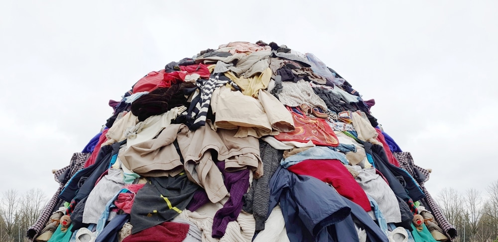 Fast fashion industry waste. A trash pile of clothing.