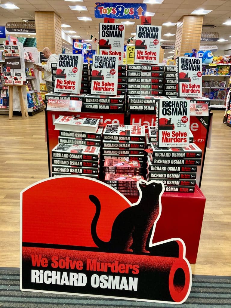 A We Solve Murders book display at Toys R US.