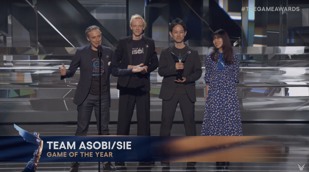 4 developers from Team ASOBI and Sony Interactive Entertainment stand on the stage to accept the game of the year award the 2024 Game Awards.