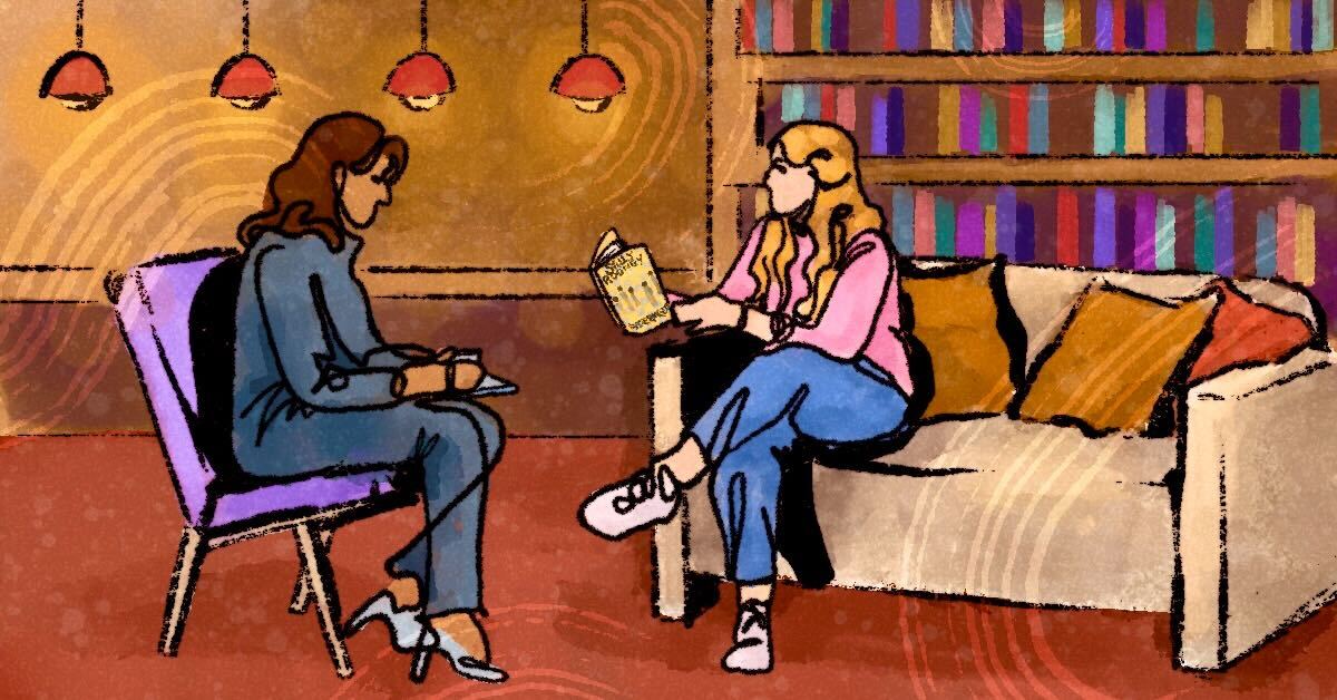 Interviewer and interviewee talking surrounded by books.
