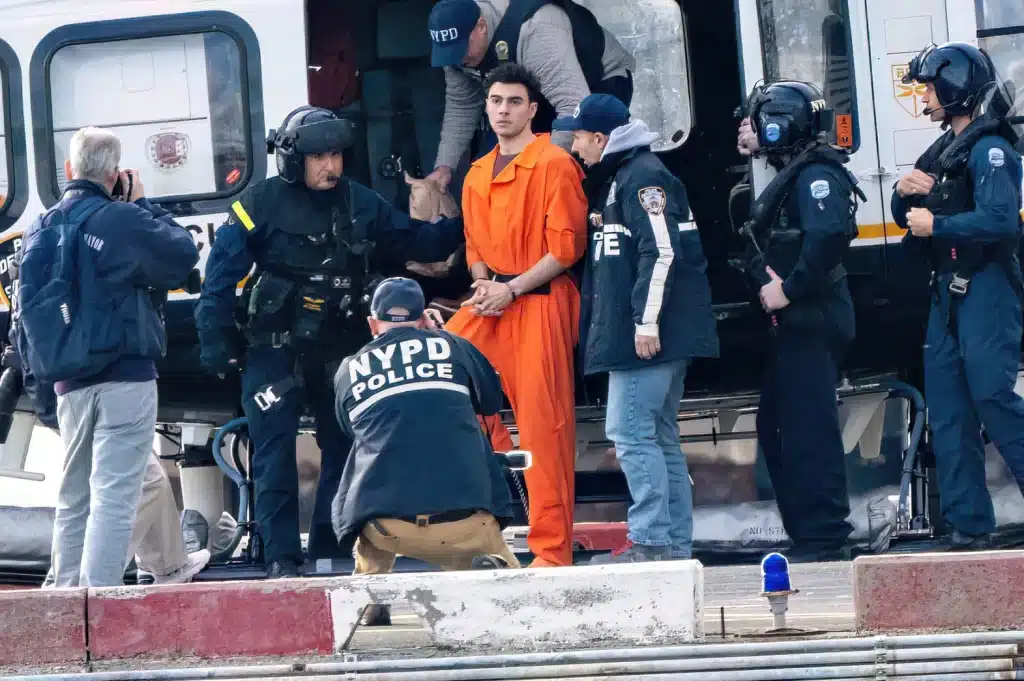 Luigi Mangione, the suspect in the murder of UnitedHealthcare CEO Brian Thompson, is seen here at the South Street Heliport after arriving on a New York Police Department helicopter in Manhattan, New York City. Credit: Theodore Parisienne/Shutterstock