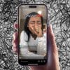 A hand is holding an iphone that is playing a TikTok video of a creator crying at the results of the 2024 election.