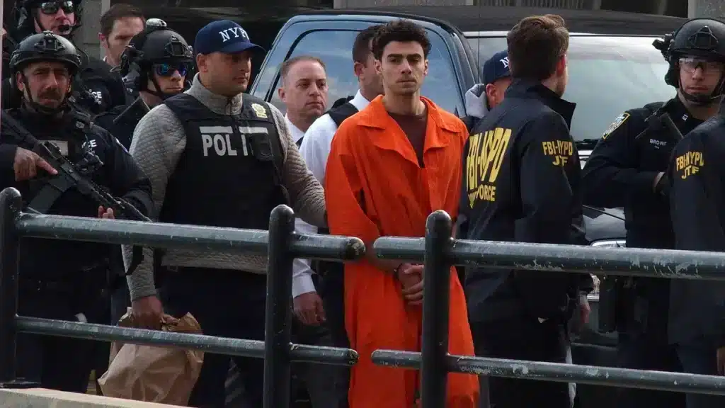 Luigi Mangione gets escorted from Helicopter by NYPD, FBI to Manhattan Federal Courthouse for arraignment on multiple charges. Credit: Samantha Cotler/ZUMA Press Wire/Shutterstock