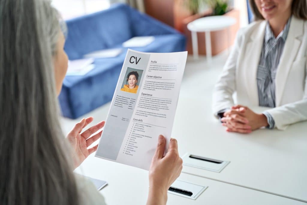 A woman reviewing the CV of a candidate.